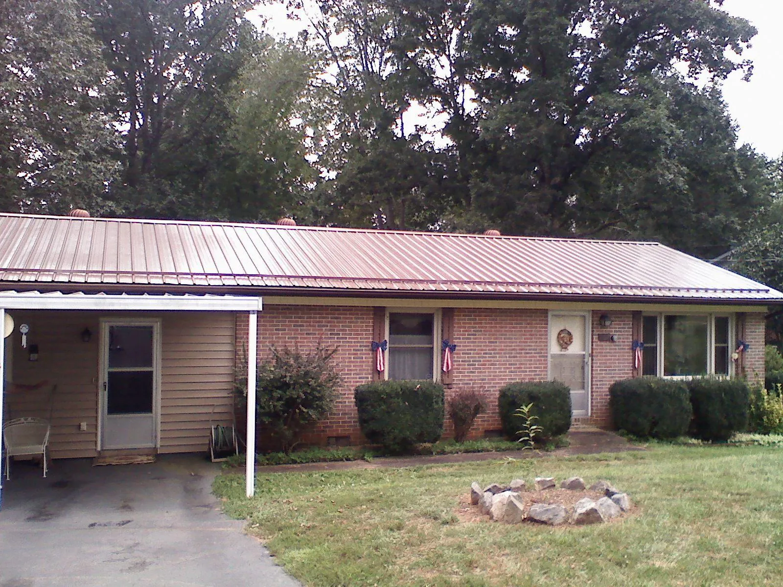 Bronze metal roof and carport on a brick ranch home — Roof Repair work by our crew in East Orange