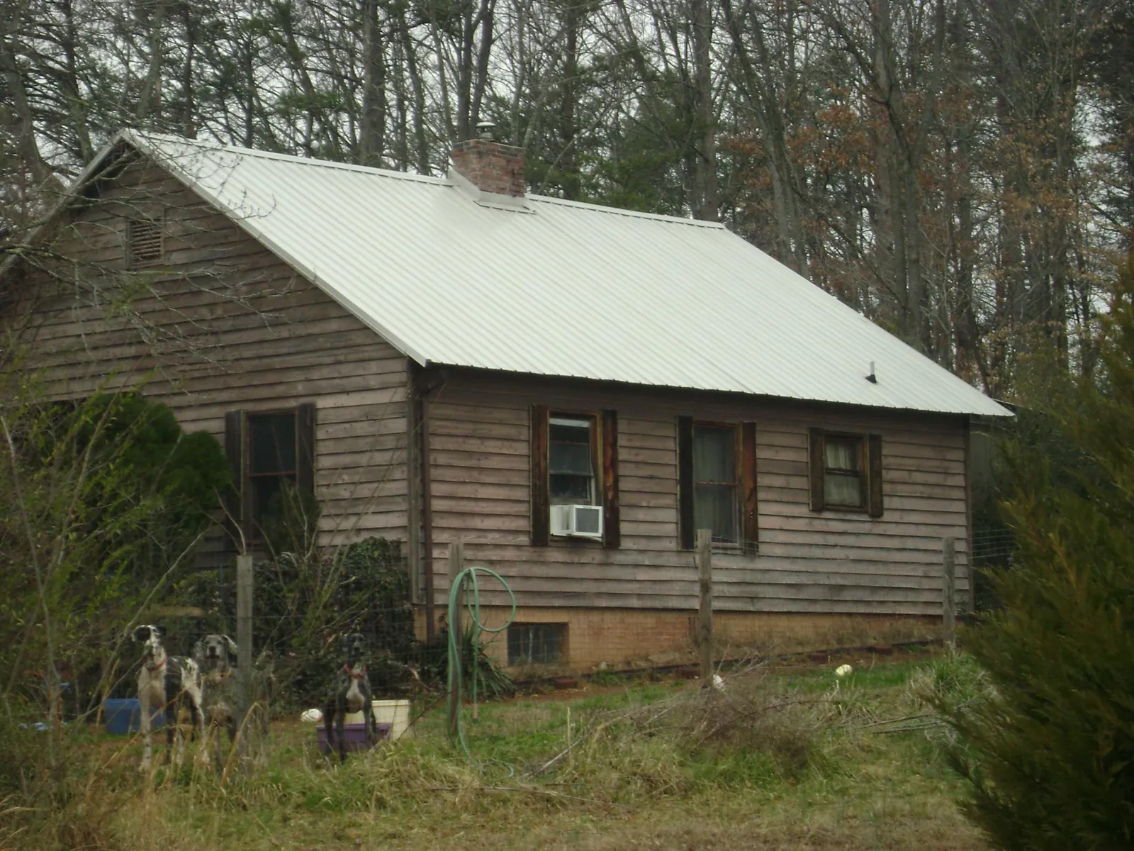 White metal roof on an old wood sided farmhouse, from a Metal Roof Installation job in East Orange